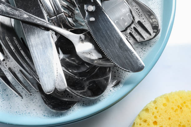 istock Plate with silverware in foam and sponge on white background, flat lay 1802709110