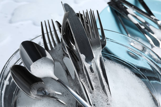 istock Glass bowl with silverware in foam, closeup 1802709639