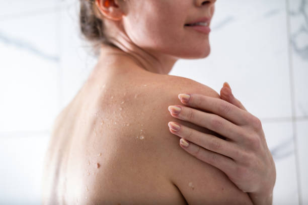 Water on skin, detail shot of a woman under shower.