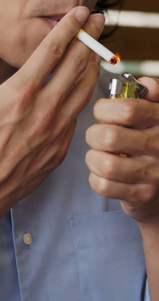 istock asian man smokes cigarette 1802734186