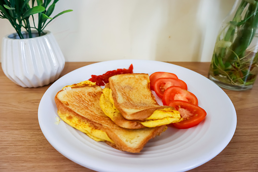 Bread toast with fried egg and tomatoes for simple breakfast