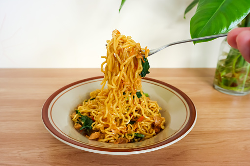 Simple fried noodle with vegetables serving on ceramic plate