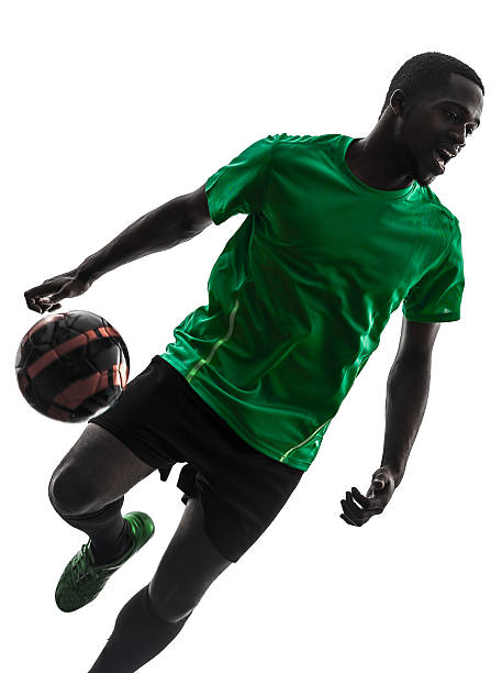 istock african man soccer player juggling silhouette 180275254