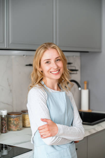 istock Cheerful young housewife have break after cooking dinner in kitchen 1802757295