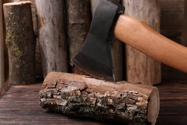 istock Metal axe in wooden log on table, closeup 1802758351