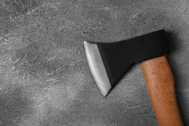 istock Metal axe with wooden handle on grey textured table, top view. Space for text 1802758877