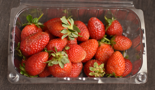 Fresh strawberries in plastic box