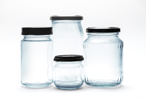 Glass transparent empty jars on white background
