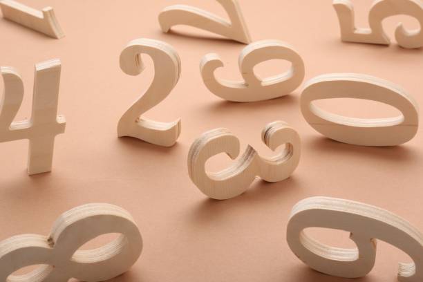istock Many different wooden numbers on beige background 1802791699