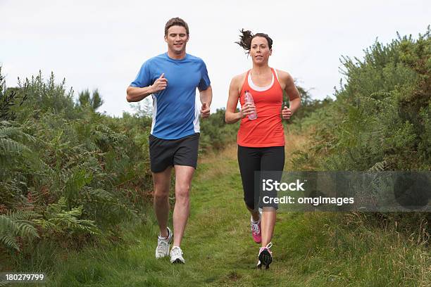 Couple On Run In Countryside Stock Photo - Download Image Now - Jogging, Couple - Relationship, Full Length