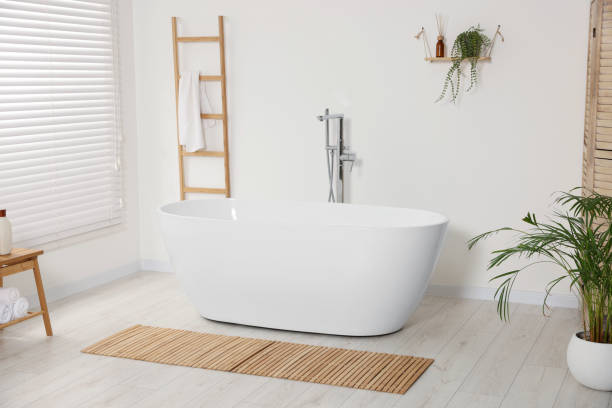 istock Stylish bathroom interior with ceramic tub and houseplants 1802799264