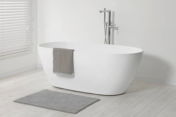 istock Stylish bathroom interior with ceramic tub and terry towel 1802806732
