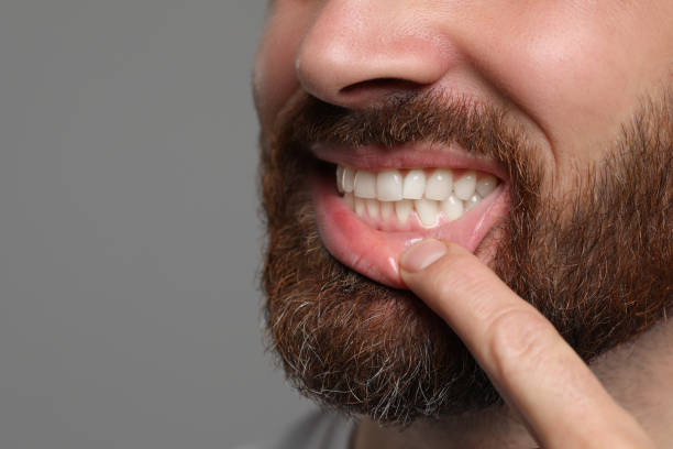 istock Man showing healthy gums on gray background, closeup. Space for text 1802823140