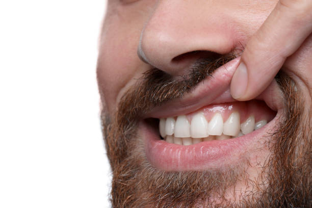 istock Man showing healthy gums on white background, closeup 1802830174