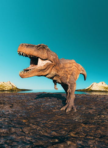 Big Tyrannosaurus Rex, also known as T-rex, roars as it moves forward through a pile of mud. In the background are mountains and the sea.