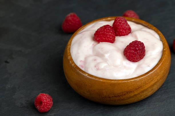 istock fresh yogurt with raspberry flavor, close up 1802839218