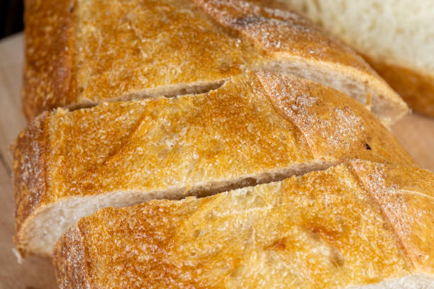 istock wheat loaf of bread close-up on the table 1802839852