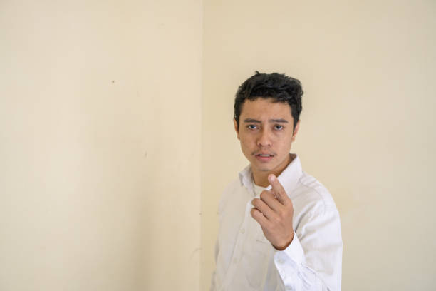 istock Indonesian man wear white clothes surprised looking to camera. 1802852501