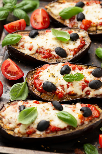 Healthy Eggplant or Aubergine pizza with tomato sauce, mozzarella cheese, basil and olives.