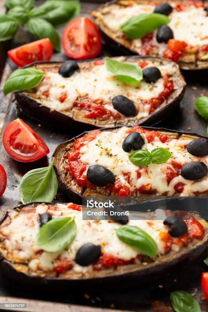 Healthy Eggplant or Aubergine pizza with tomato sauce, mozzarella cheese, basil and olives Healthy Eggplant or Aubergine pizza with tomato sauce, mozzarella cheese, basil and olives. Olive - Fruit Stock Photo