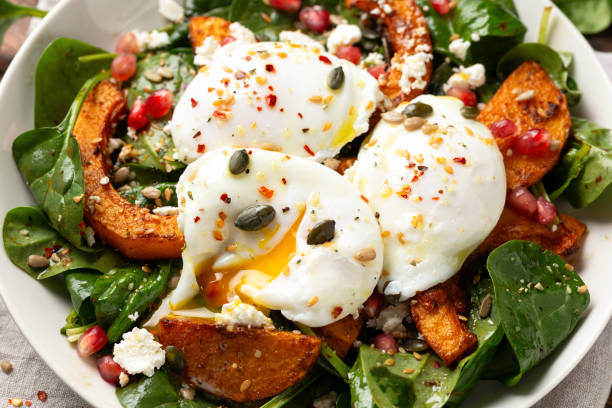 istock Roasted butternut squash salad served with poached eggs, spinach, nuts and pomegranate seeds 1802880008