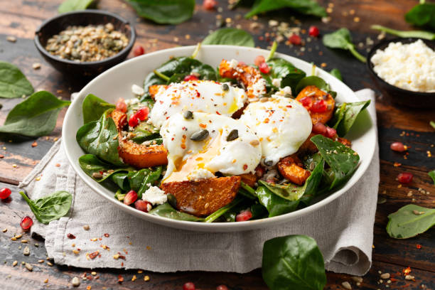 istock Roasted butternut squash salad served with poached eggs, spinach, nuts and pomegranate seeds 1802880009