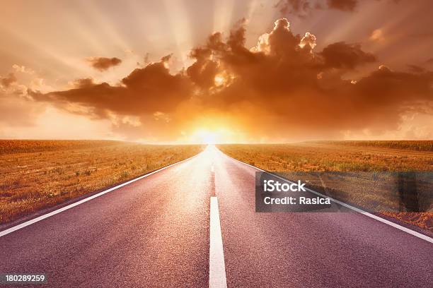 Driving On Empty Road Towards The Setting Sun Ii Stock Photo - Download Image Now - Road, Agricultural Field, Agriculture