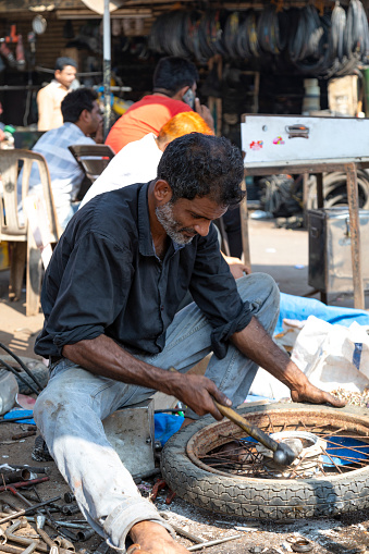 21st January, 2020 - Mumbai, India: This editorial image offers a vivid glimpse into the bustling Chor Bazar, one of Mumbai's oldest and most famous markets. Known as 'Thieves Market', Chor Bazar has a rich history and is a treasure trove of antiques, vintage items, and eclectic goods. The photograph captures the vibrant energy of the market, featuring traders, locals, and shoppers immersed in the lively atmosphere. Traders are seen displaying an array of items, from intricately designed artifacts to second-hand goods, while shoppers navigate through the narrow lanes, exploring and haggling. The image aims to reflect the market’s chaotic charm and its role as a cultural and commercial melting pot in the heart of Mumbai.