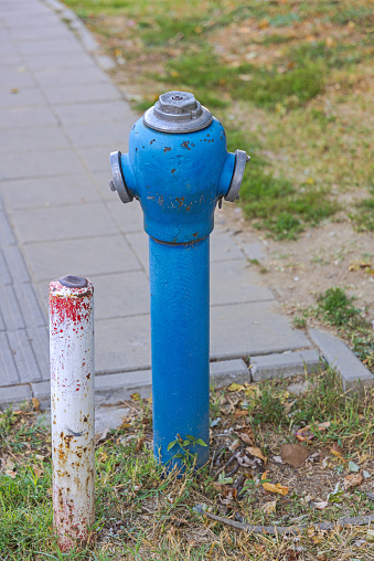 Old fashioned blue hand pump with handle for pumping