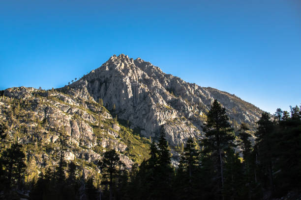 istock Silhouetted Shadowed Trees in Front of Mountains in Lake Tahoe, CA 1802931561