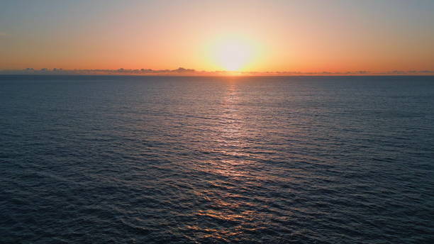 istock Orange sunset marine horizon landscape drone view. Sundown reflecting calm water 1802947765