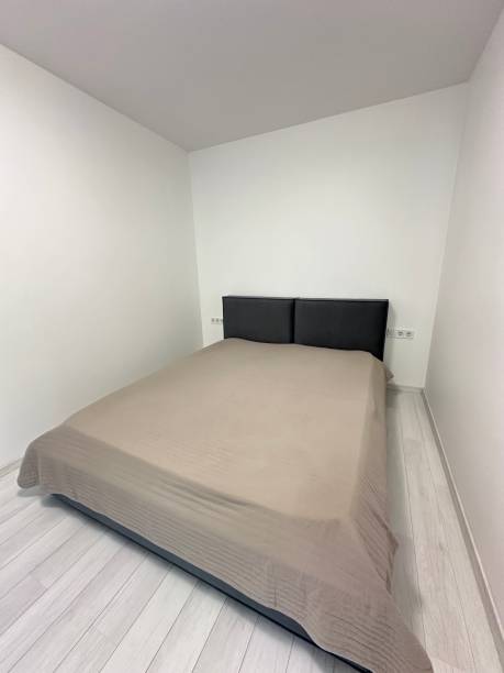 istock bed in a room with white walls 1802963701