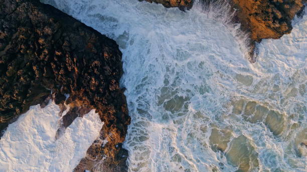 istock Drone view stormy ocean waves breaking at volcanic coastal. Closeup 1802965851