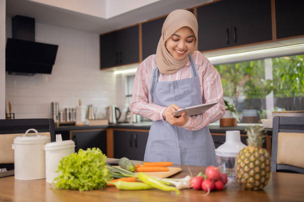 istock Joyful woman is preparing a healthy meal 1802989767