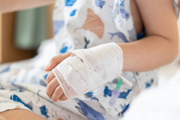 istock Close up child hand with saline IV solution in hospital 1802989939