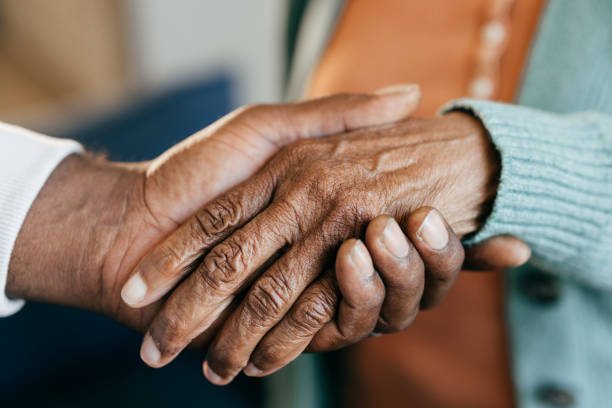 Young woman holding elderly hands