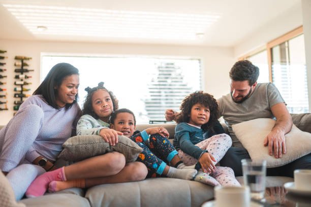istock Multiracial Family Sitting on a Cozy Gray Couch 1803008800