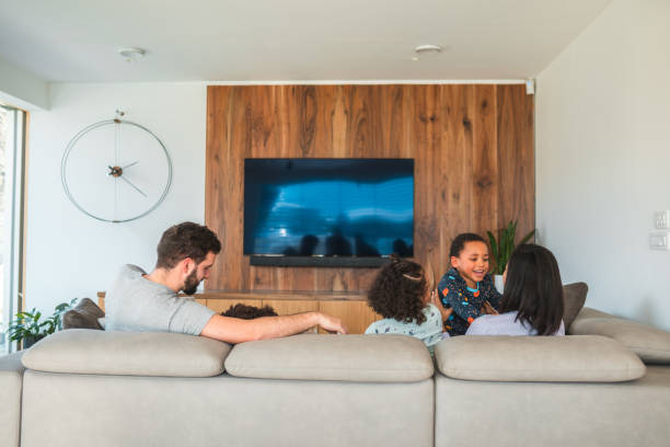 istock Back View of Mixed Race Family Seated on a Modern Couch 1803009294
