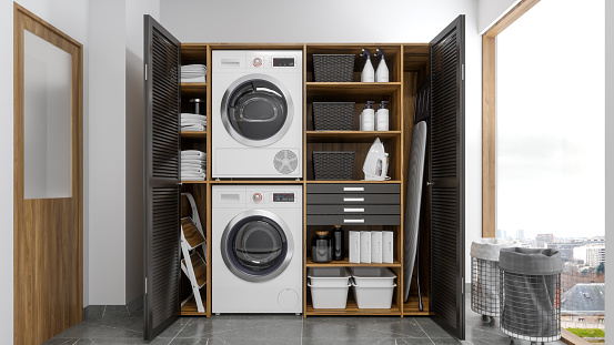 Modern Laundry Room With Washing Machine, Dryer And Cabinets