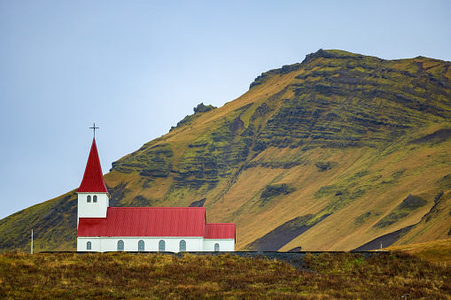 red roofed church on a hill in Vik, Iceland