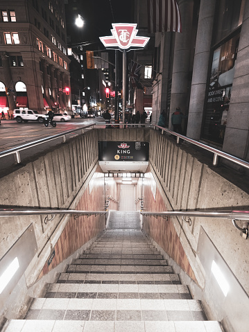 Toronto, Ontario, Canada - November 09, 2023:  The street level entrance to the Toronto Subway system (TTC).   This particular entrance is located on King street in the heart of the Financial District in downtown Toronto.