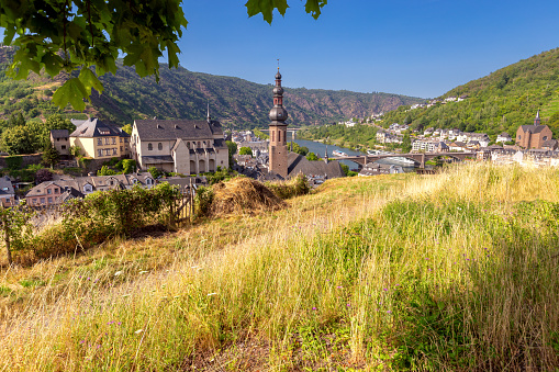 The old medieval town Cochem and the mountain slopes above the Moselle river on a sunny day. Germany.