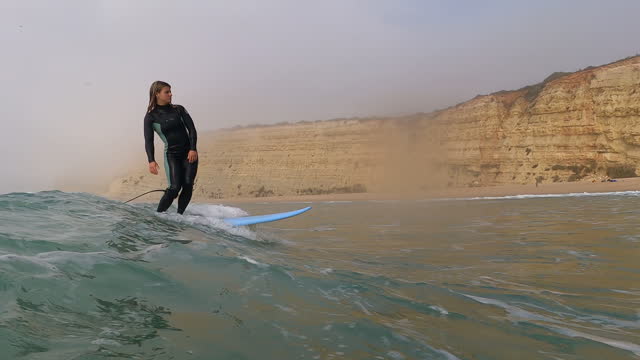 First person perspective of young woman surfing