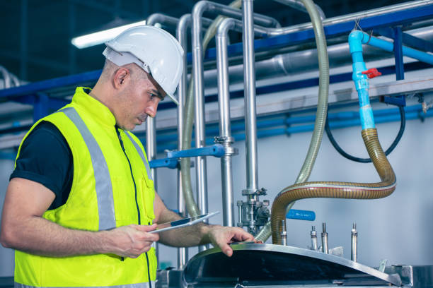 istock Engineer male worker working in factory using tablet computer to check boiler water tank pipe in factory. 1803053044