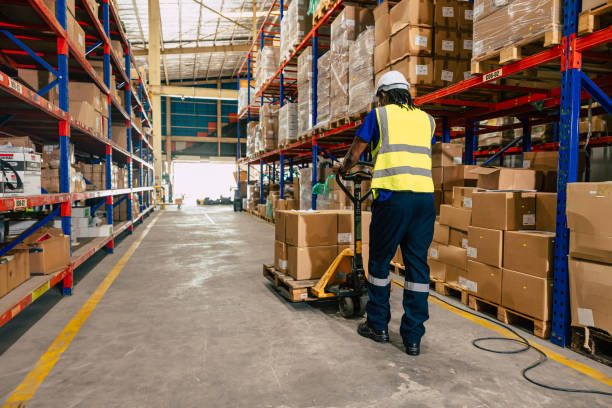istock african black warehouse worker using parcel pallet moving cargo for logistics shipping supply management industry 1803053622