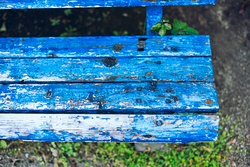 Shabby blue bench in the park
