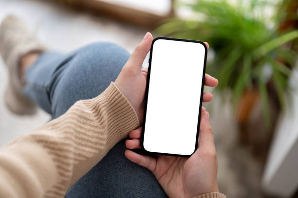 istock A white-screen smartphone mockup in a woman's hand. social media, mobile application, chatting 1803161443