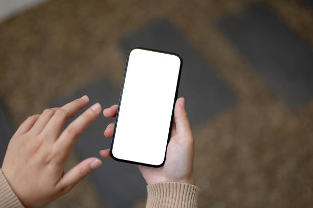 istock A woman using her smartphone outdoors. A white-screen smartphone mockup in a woman's hand 1803162012