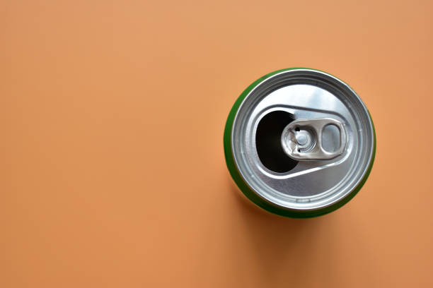 istock aluminum green drink cans on orange background, open cold fresh beverage 1803175202