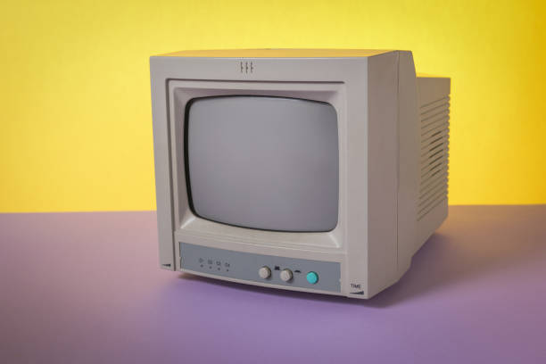 istock A small retro TV on a purple and yellow background. 1803179611